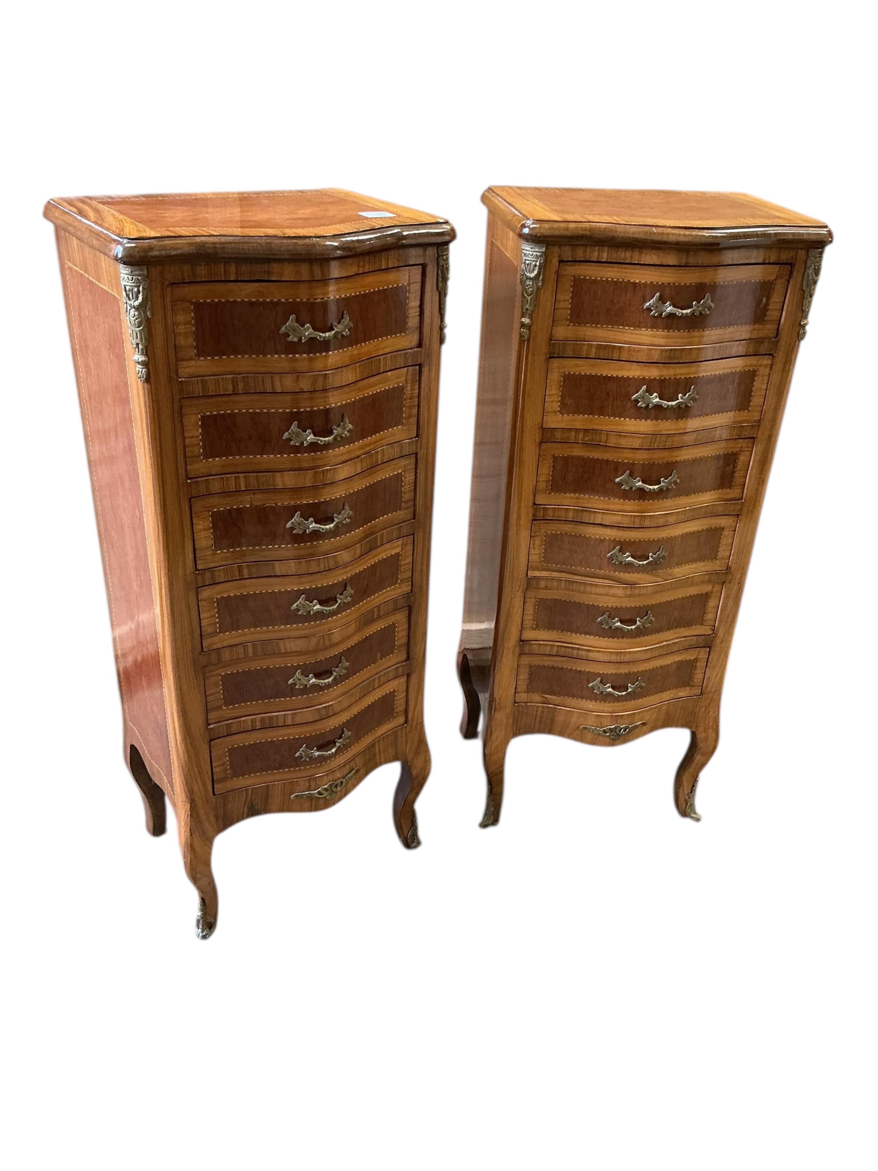 A pair of reproduction gilt metal mounted kingwood banded serpentine narrow seven drawer chests, width 45cm, depth 35cm, height 108cm
